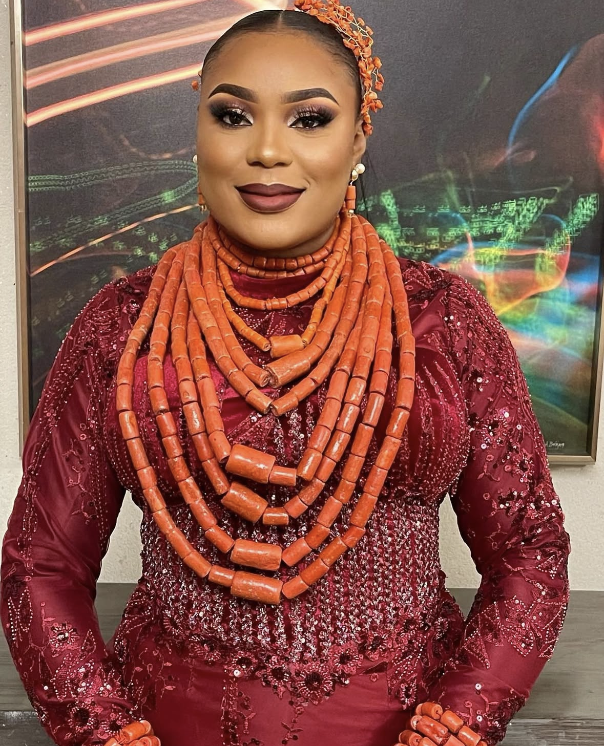 Traditional coral bead necklaces and headpiece with maroon sequin attire