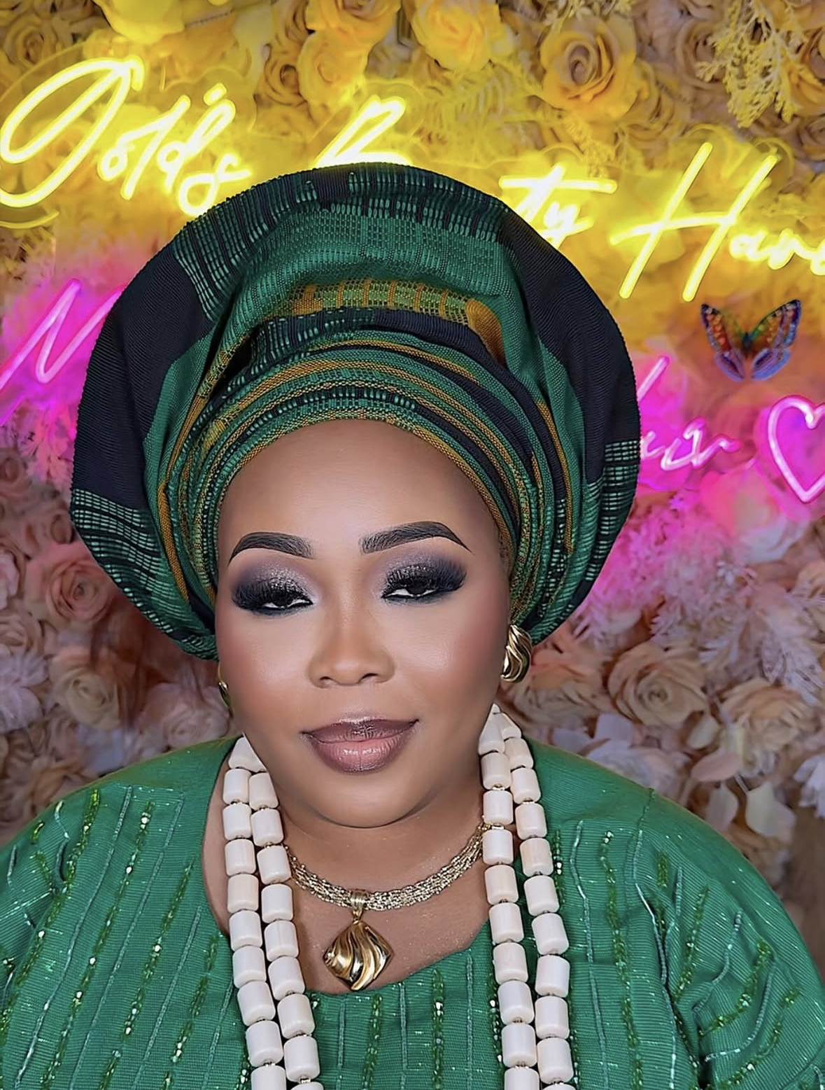 Traditional green gele with cream bead necklaces